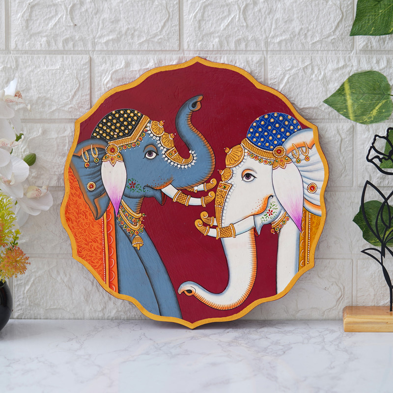 Traditional Pichwai elephant art on maroon background — handcrafted wall decor for a regal aesthetic.