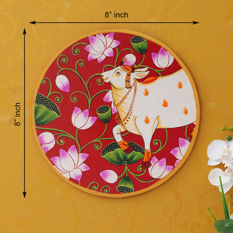 Sacred cow Pichwai painting on red background — elegant Rajasthani art for living room or temple wall.