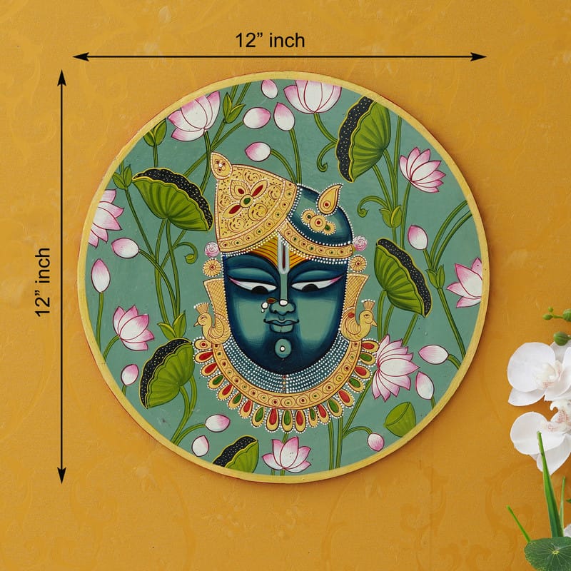 Blue-hued Krishna face Pichwai art surrounded by lotuses — divine Indian traditional wall painting.