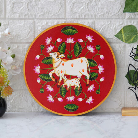 Spiritual Pichwai cow and lotus artwork in red tones – elegant Indian wall decor for home and temple.