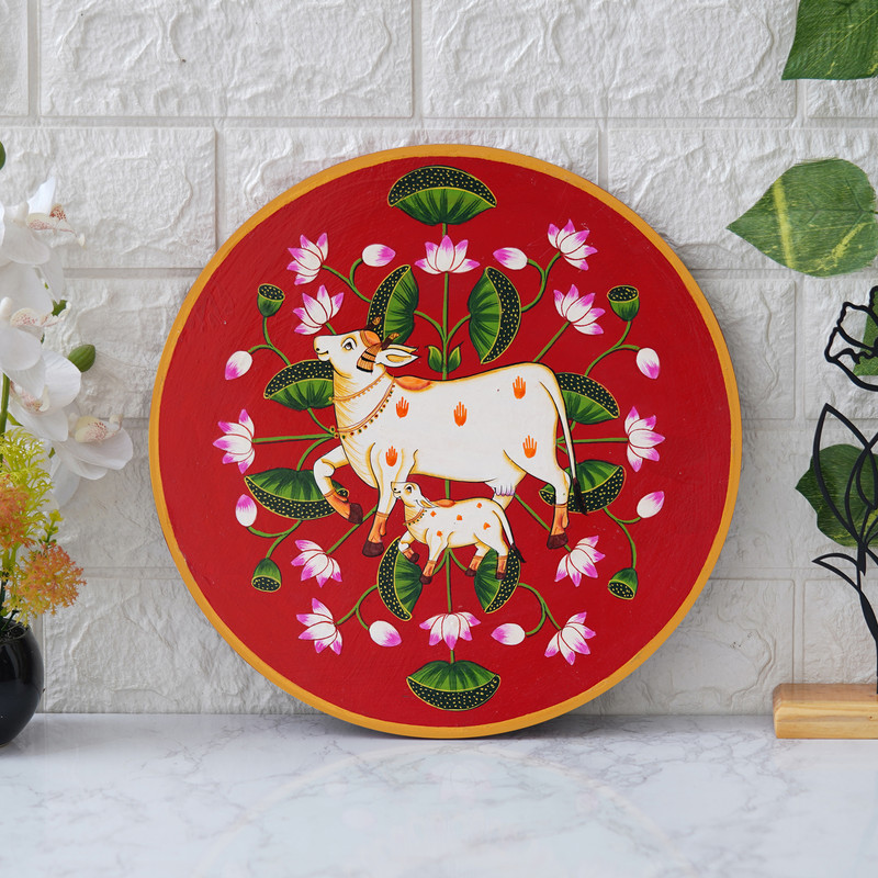 Spiritual Pichwai cow and lotus artwork in red tones – elegant Indian wall decor for home and temple.