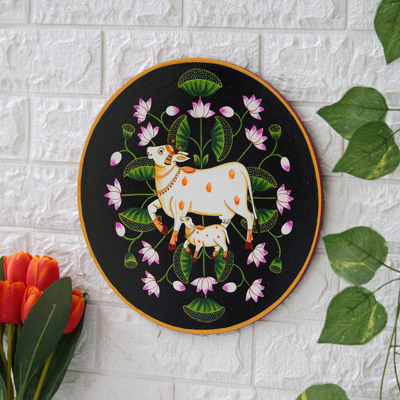 Handmade-style cow and calf Pichwai digital painting – ethnic Rajasthani decor in black and pink tones.