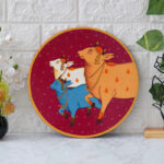 Traditional Indian Pichwai artwork depicting holy cows in festive colors – spiritual home wall decor piece.