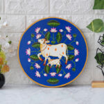 Colorful blue background cow and lotus digital wall painting – elegant traditional decor for pooja or living room.