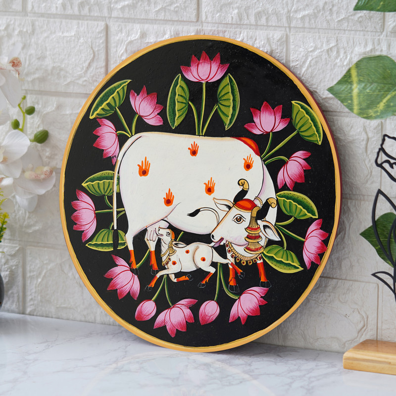Traditional Pichwai cow and calf painting with lotus flowers – spiritual Indian wall art decor for home.