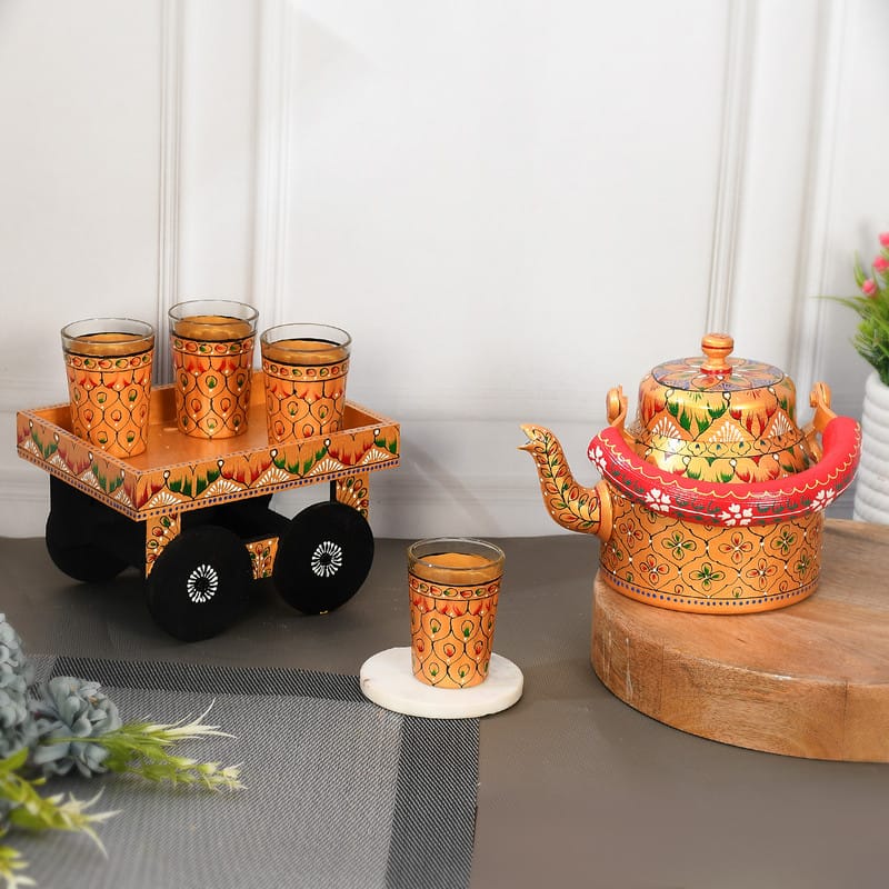 Colorful enamel-painted Indian tea set featuring traditional yellow and red motifs
