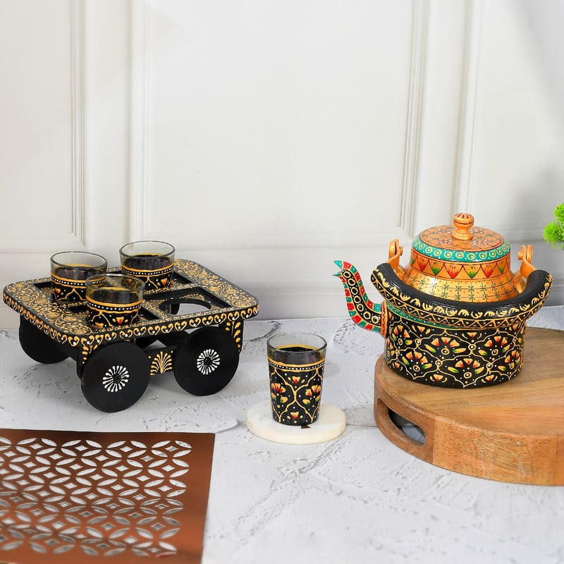 Hand-painted black and orange wooden tea cart with matching floral kettle and glasses
