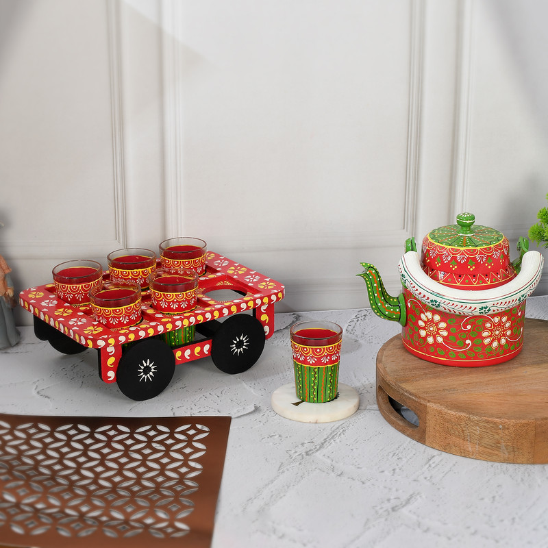 Colorful Indian art-inspired tea set featuring traditional festive red and green patterns