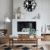 Black and white metal wall art clock for modern living room decor.