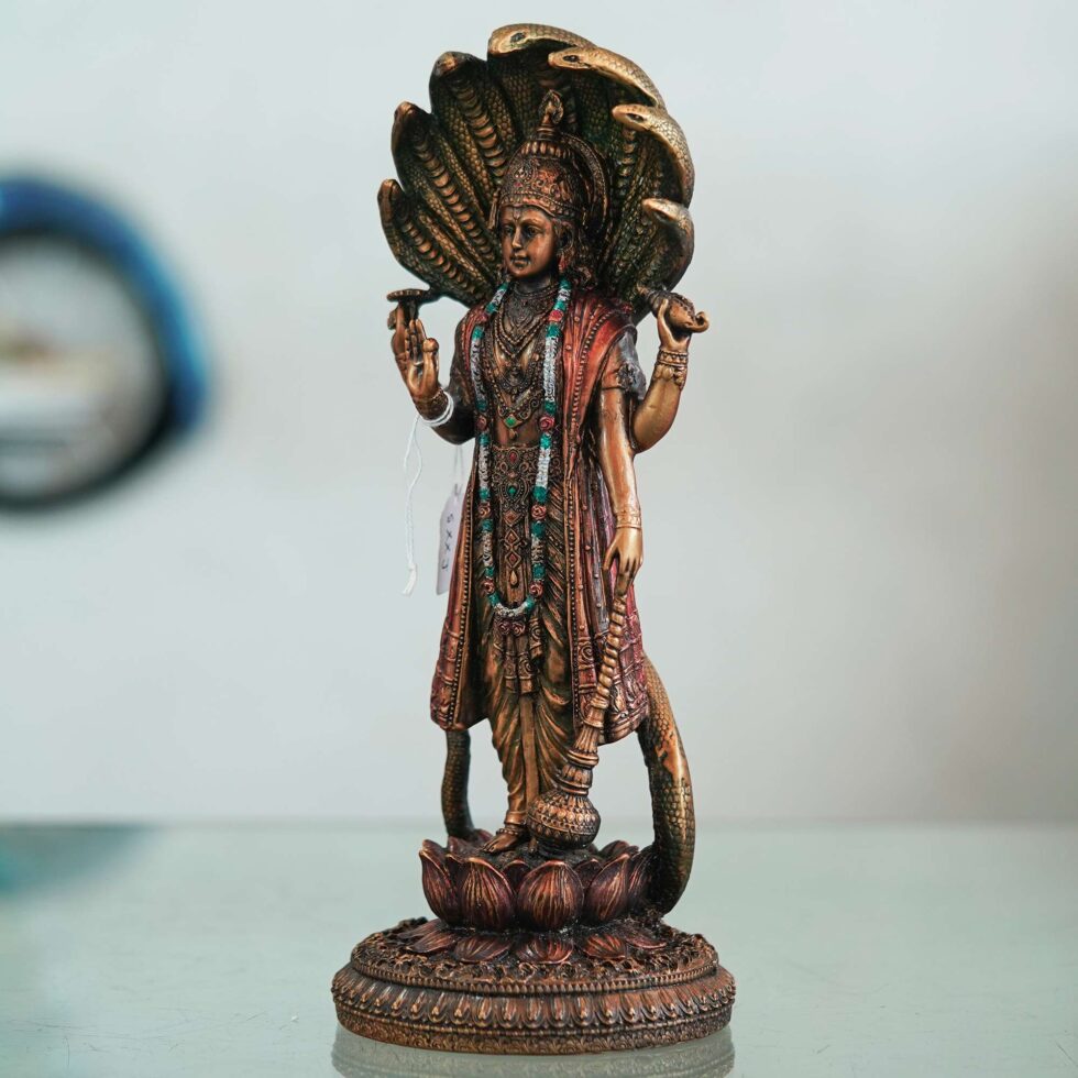 Artisan-crafted bronze Vishnu figurine with serpent canopy, elegant handmade decor for Diwali