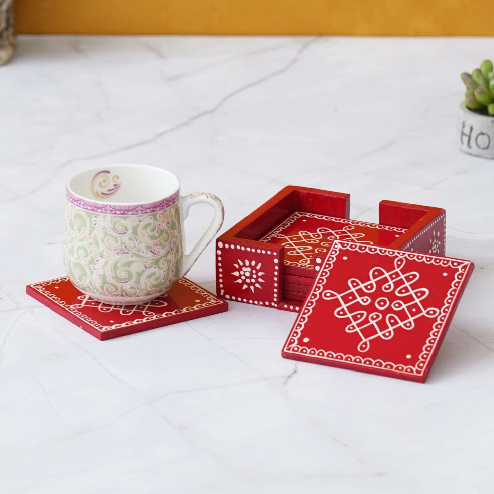 Hand-painted red wooden coaster set with traditional white rangoli art – perfect for festive table décor