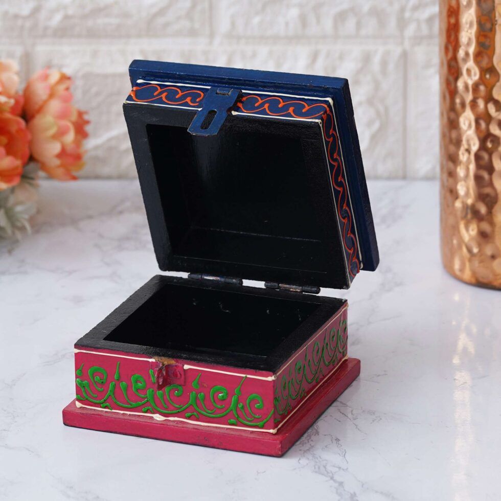 Artistic hand-painted wooden boxes showcasing Indian craftsmanship.
