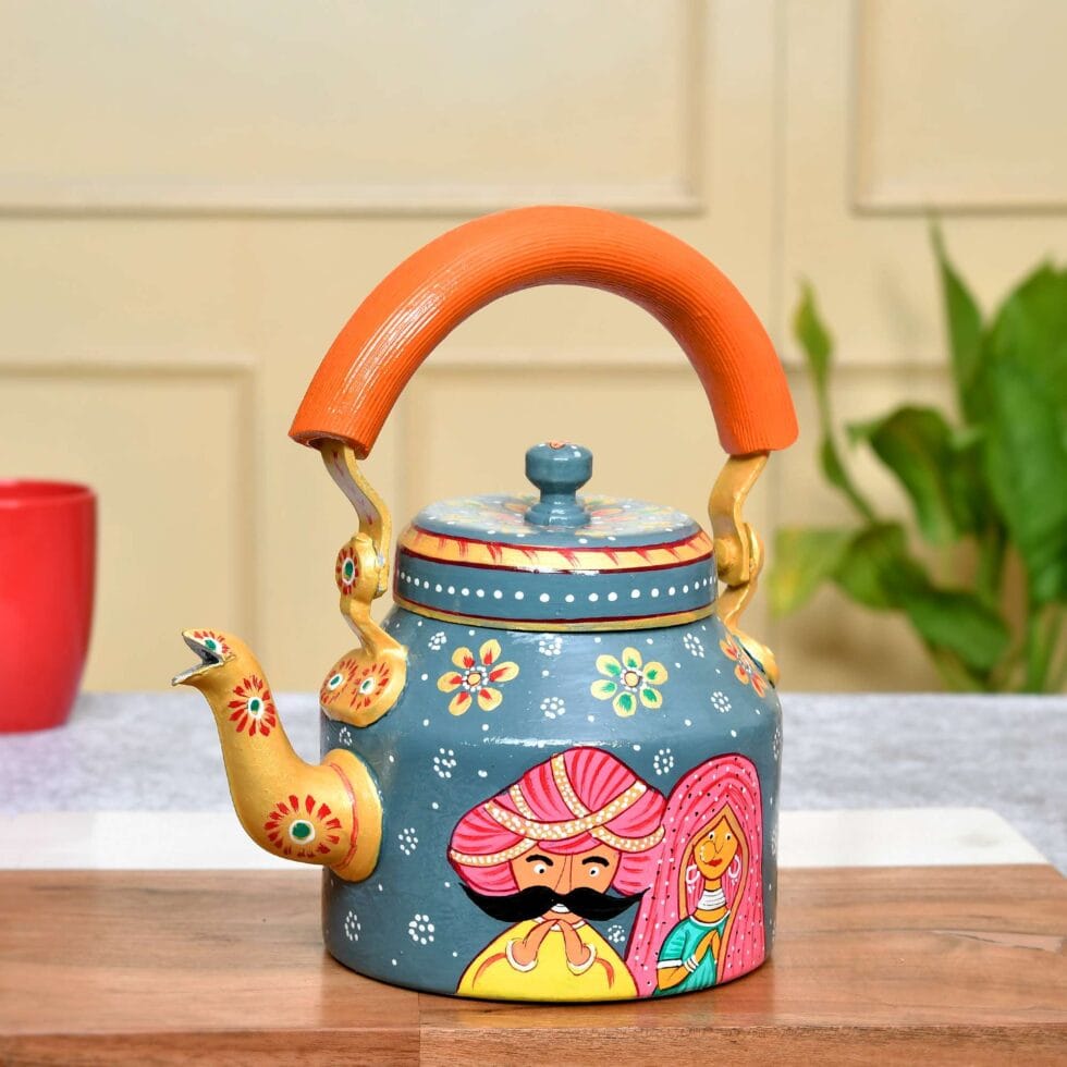 Colorful enamel-painted steel tea kettle with traditional Indian folk art pattern