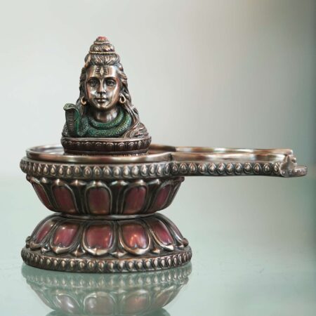 Artisan-crafted bronze Shiva diya with snake design, elegant handmade decor for festive interiors