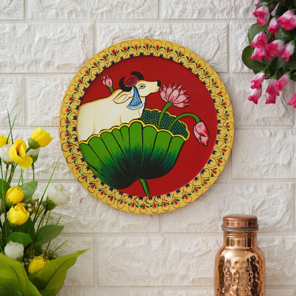 Vibrant Pichwai cow painting on red background – traditional Indian decor for pooja room or gifting.