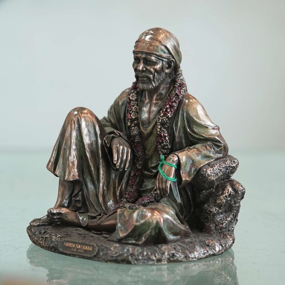 Artisan-crafted bronze Sai Baba sculpture with intricate detailing, ideal for home temple decoration